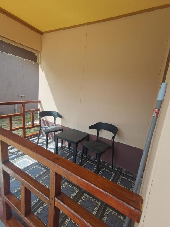 a room with four chairs and a table in it at Permata Beach Chalet in Kampong Juara
