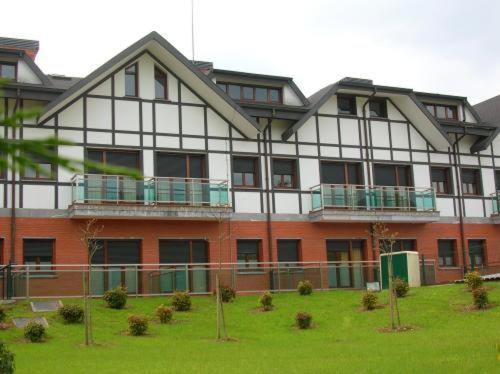 a large building with a lawn in front of it at Euba Hotel in Amorebieta-Etxano