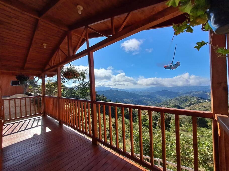 uma varanda de uma casa com vista para as montanhas em Cabaña Gitana - Magical and WINDY nature getaway! em Jardín