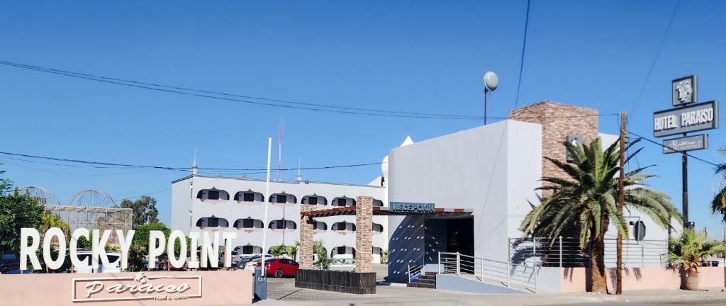 a white building with a rock pow sign in front of it at Hotel Paraiso in Puerto Peñasco