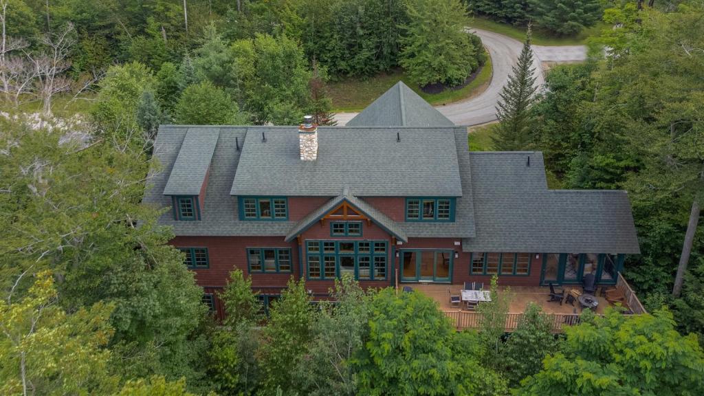an aerial view of a house in the trees at Grand Fireplace Pool Table Wifi Sleeps 18 in Lincoln