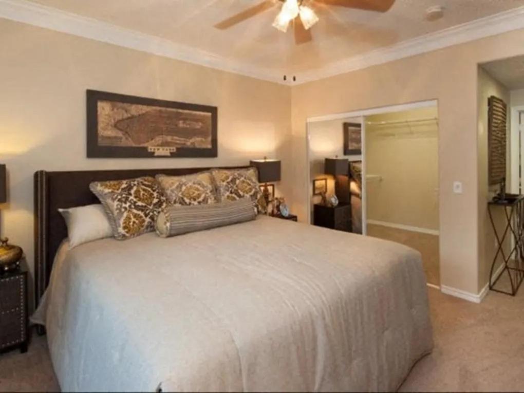 a bedroom with a large bed with a ceiling fan at Quin11 in Houston