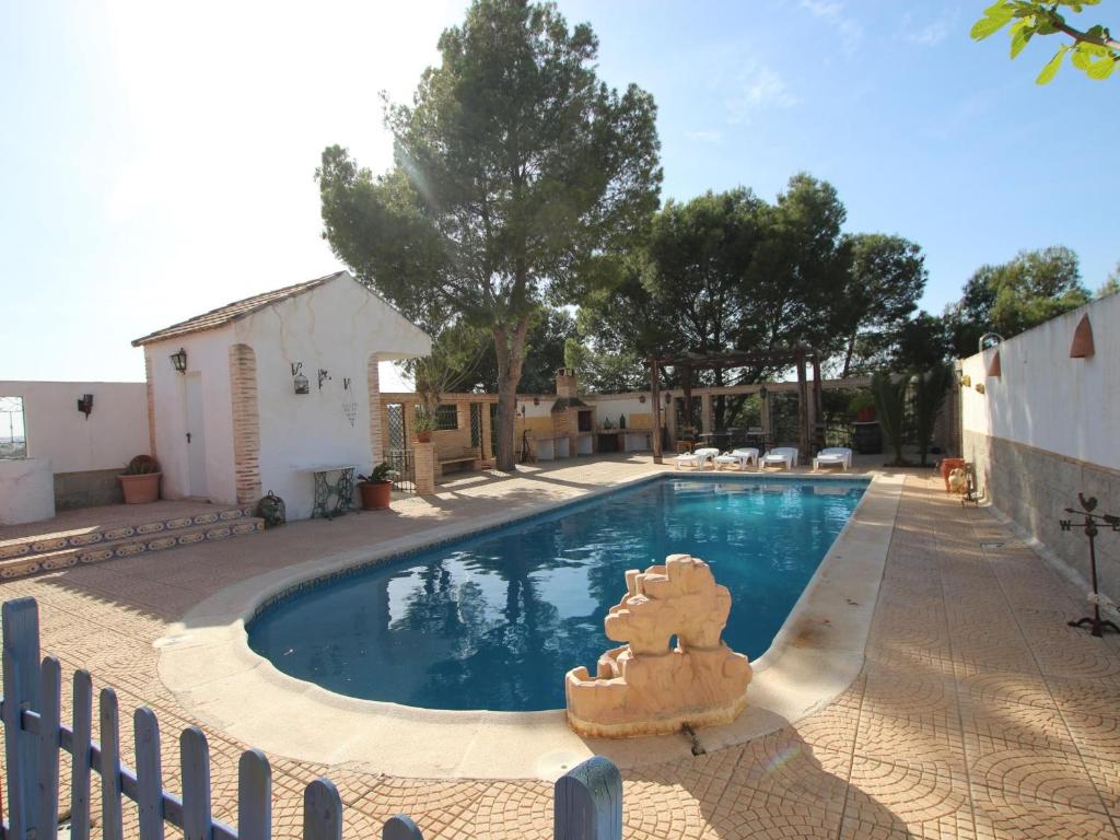 a swimming pool with a teddy bear statue next to it at Villa Murcia, 5 dormitorios, 10 personas - ES-220-34 in Alcantarilla