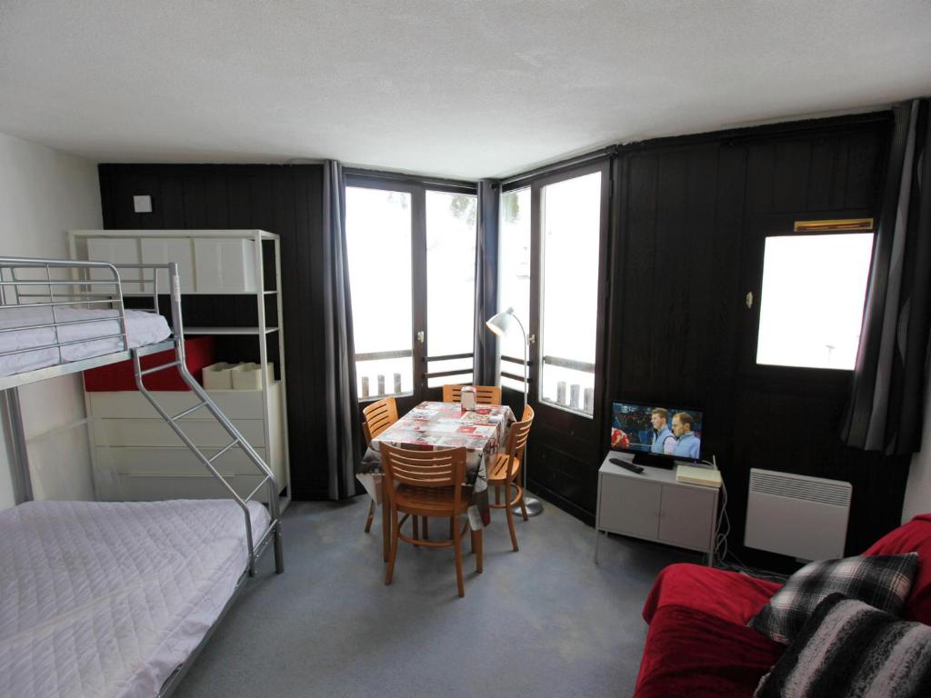 a bedroom with a bed and a table and chairs at Studio Avoriaz, 1 pièce, 3 personnes - FR-1-314-280 in Morzine