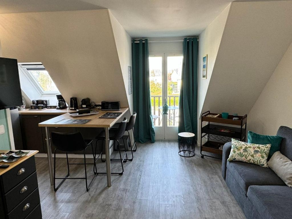 un salon avec une table et un canapé dans l'établissement Appartement 3 pers refait à neuf près plage/thalasso à Cabourg, balcon, cuisine équipée - FR-1-487-366, à Cabourg