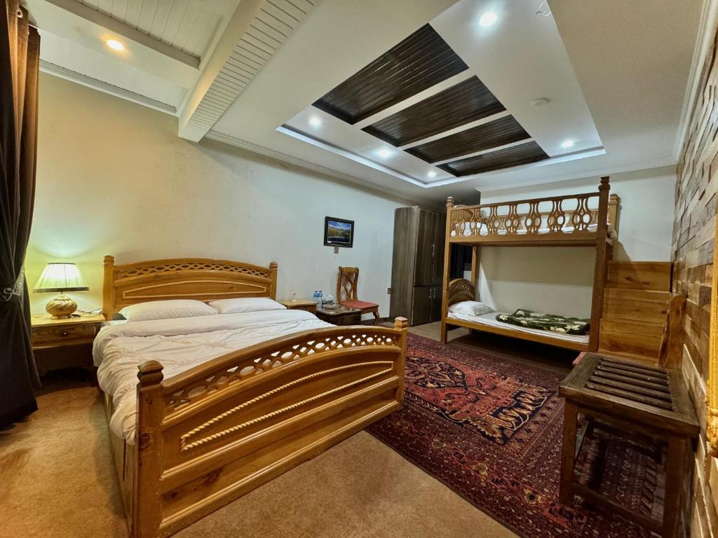 a bedroom with a large wooden bed and a fireplace at Lavender Cottage and Guest House in Skardu
