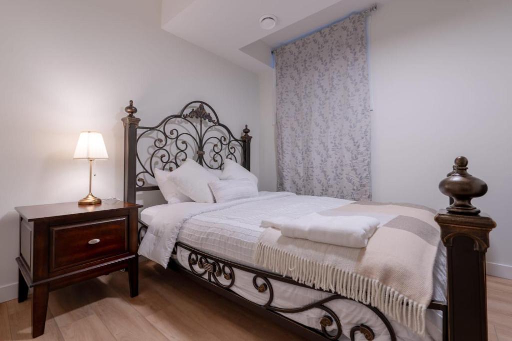 a bedroom with a black and white bed and a table at Peaceful basement, Calgary city in Calgary