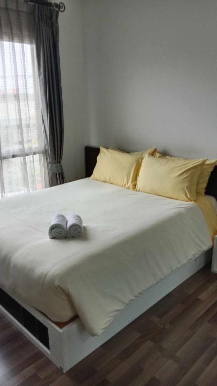 a bed with two towels on top of it at Otto Stay BKK airport 10 mins, Near Malls & Night Market in Ban Khlong Lat Bua Khao