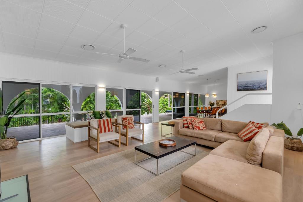 a living room with a couch and a table at Ohana Palm Cove in Palm Cove