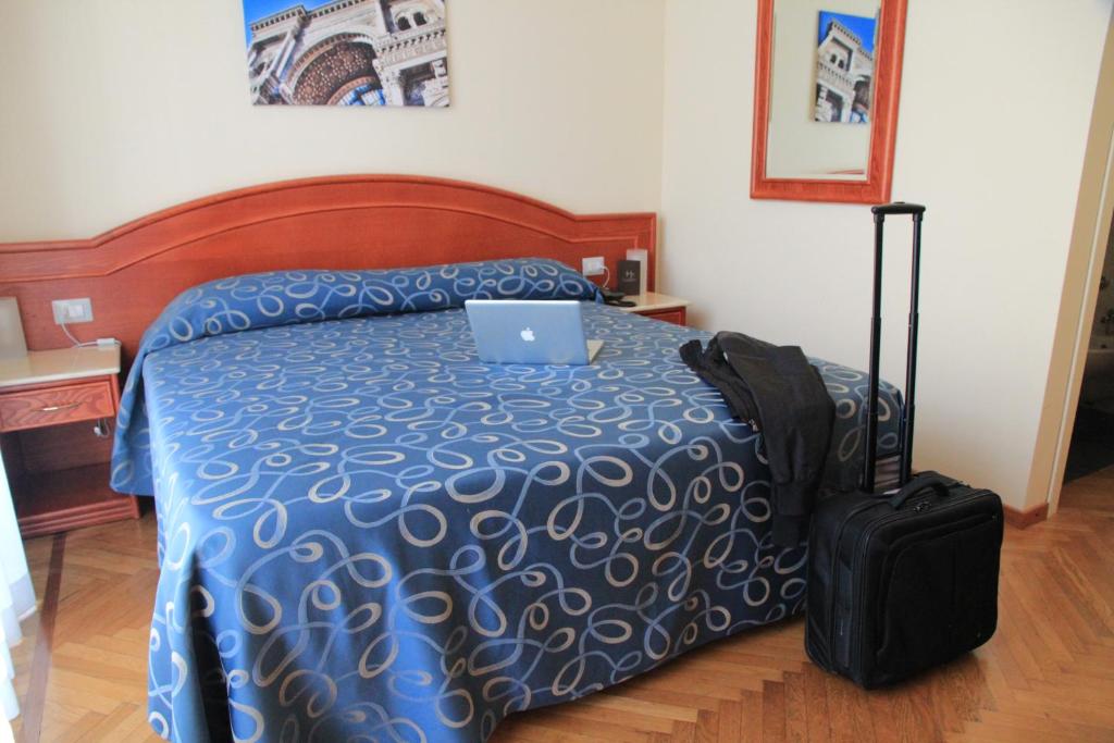 Postel nebo postele na pokoji v ubytování Hotel Palladio