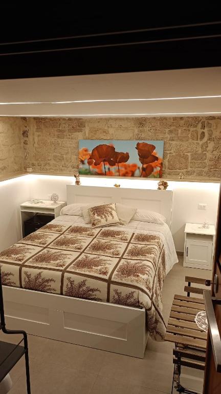 a bedroom with a large bed and two tables at IL CORTILETTO in Bari