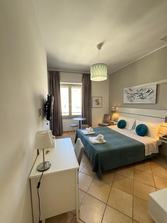 a bedroom with a bed and a table and a room at San Pietro Otranto in Otranto