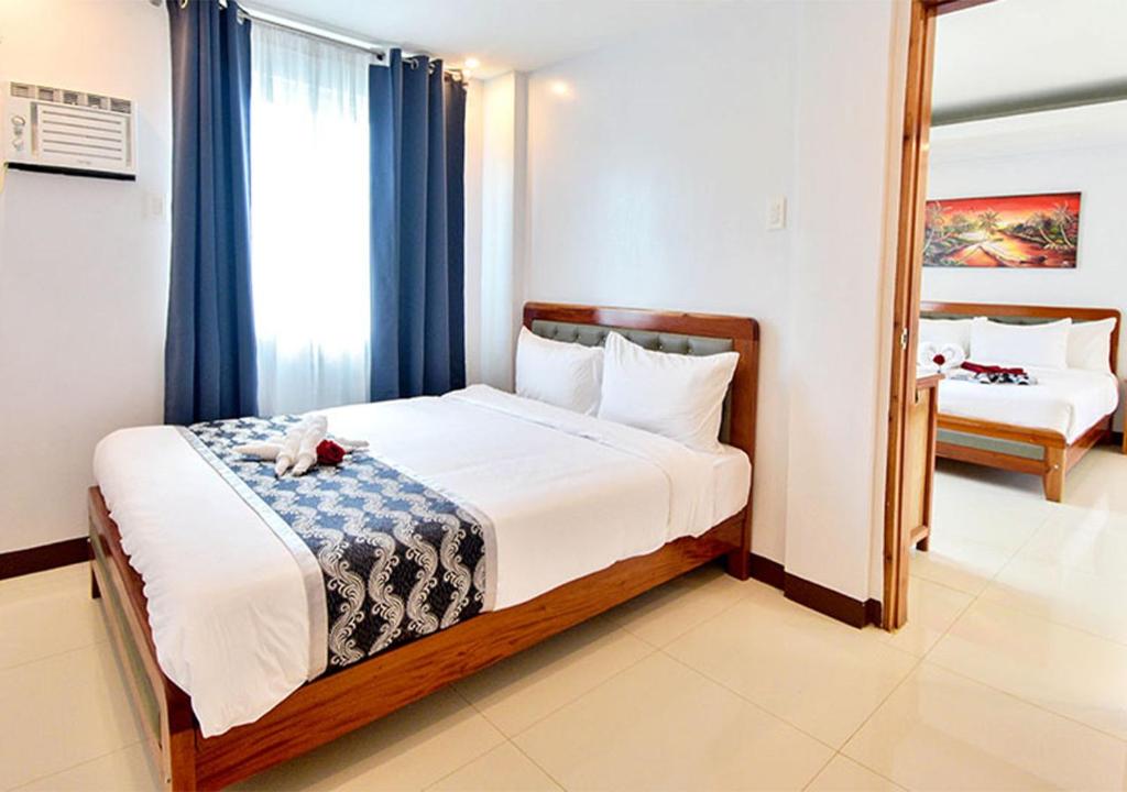 Postel nebo postele na pokoji v ubytování The XIMO Suites