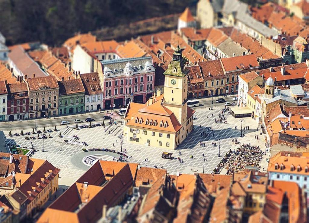 an overhead view of a city with buildings and a clock tower at City Tales Residence in Braşov