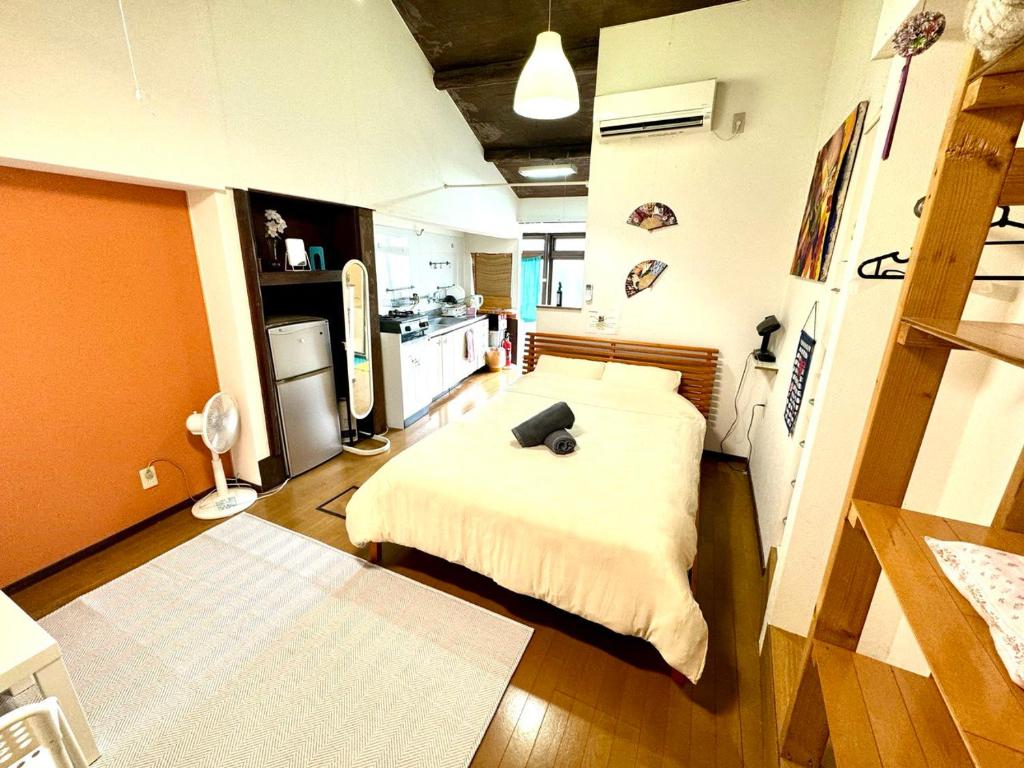 a small room with a bed and a kitchen at Kyoto G in Kyoto