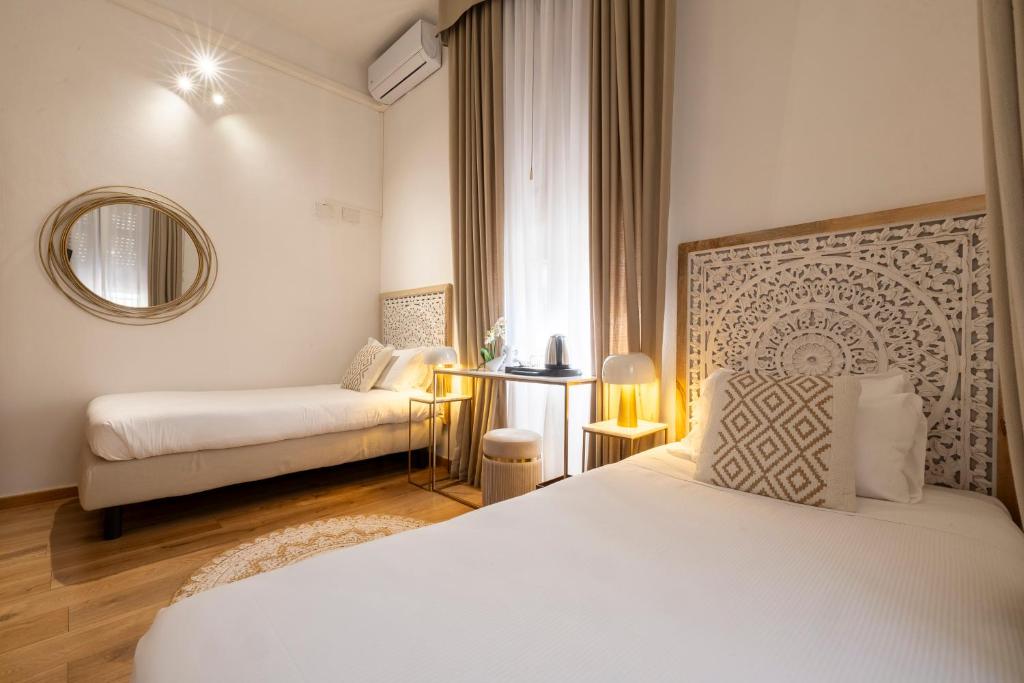 Postel nebo postele na pokoji v ubytování Hotel Bagliori