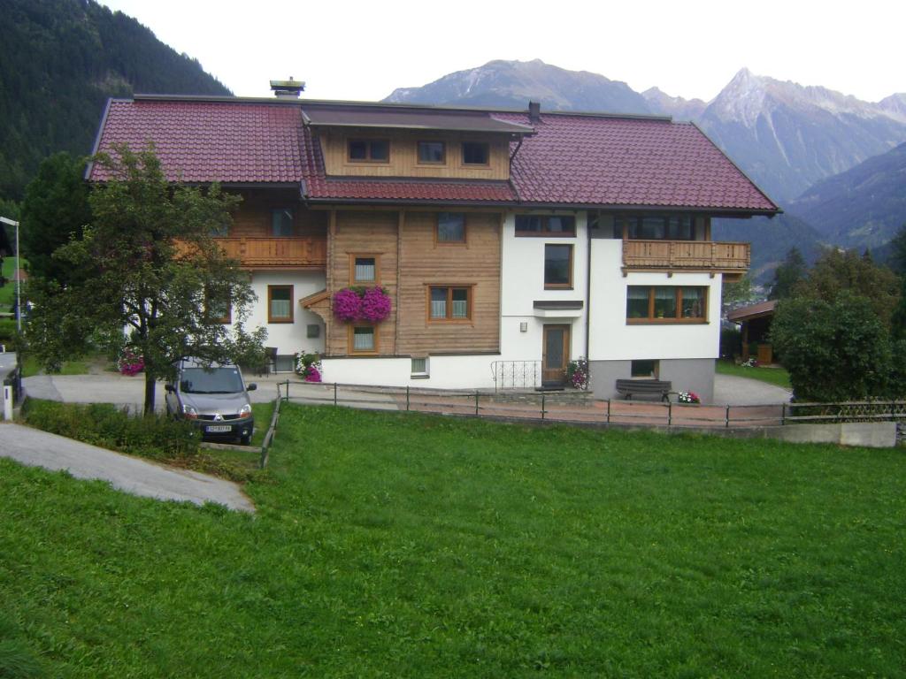 a house with a car parked in front of it at Haus Sonnegg in Finkenberg