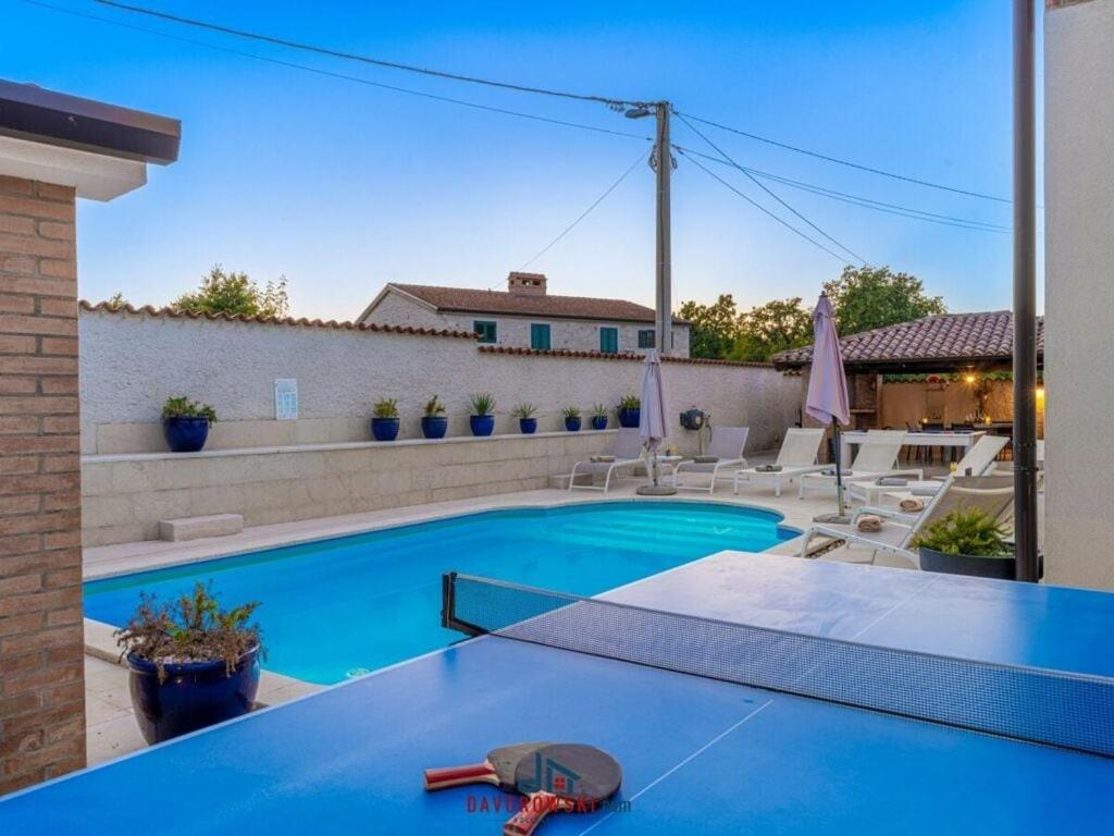 - une piscine avec une table dans l'arrière-cour dans l'établissement Artist Comfortable holiday residence, à Poreč