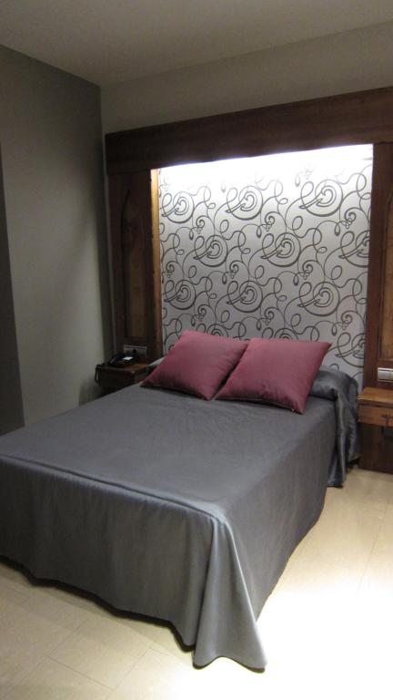 Postel nebo postele na pokoji v ubytování Hotel La Brasa