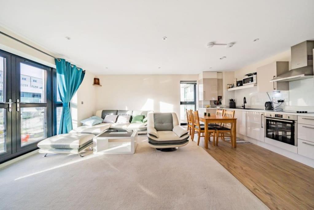 a living room with a couch and a table at Luxury Flat in Welwyn Garden City