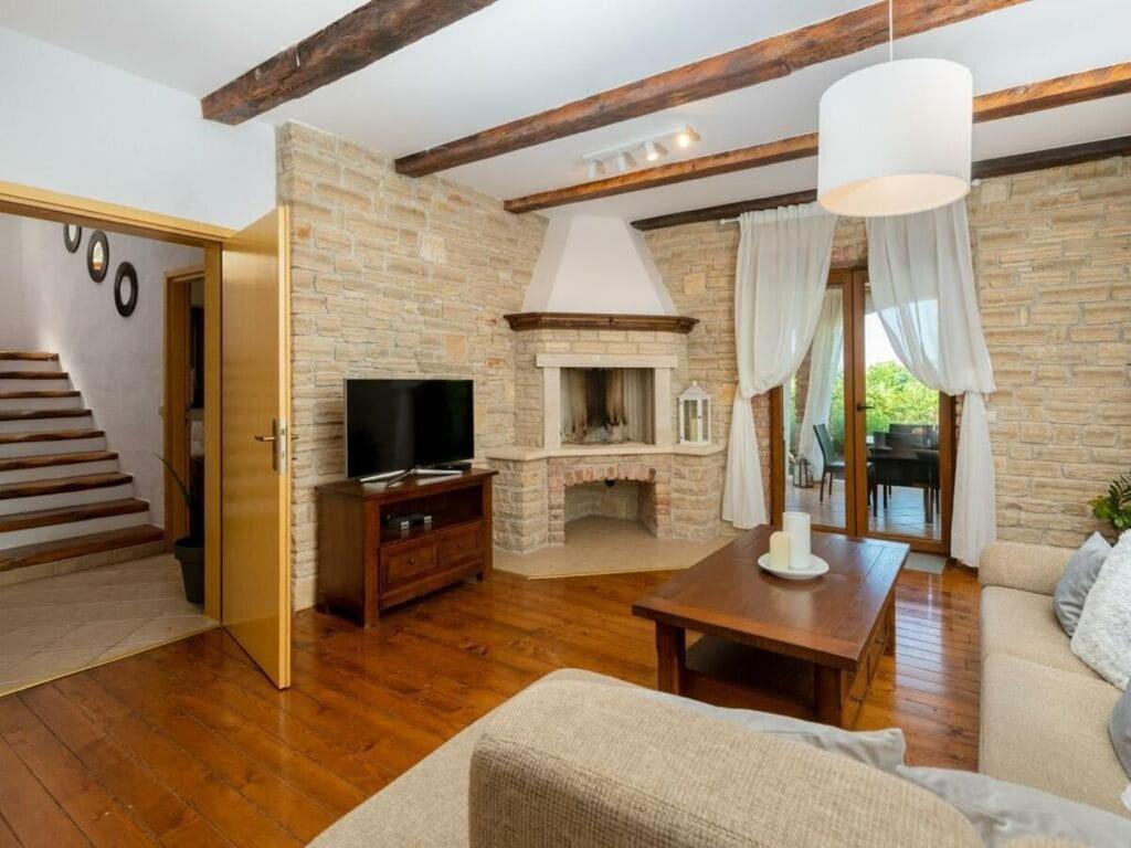 a living room with a couch and a fireplace at Villa Wish Comfortable holiday residence in Čabrunići