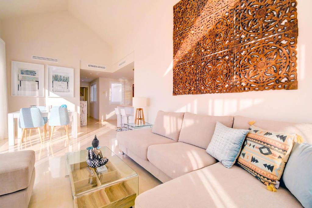 a living room with a couch and a table at Luxury Penthouse Alcazaba Lagoon 521 EHHouse in Estepona