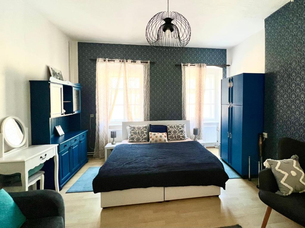 a bedroom with blue walls and a bed in a room at Apartman Natalya Gold Cesky Krumlov in Český Krumlov