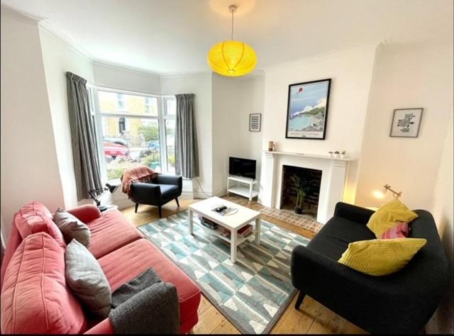 a living room with a couch and a fireplace at *Family Home in Mumbles. Close to the Beach* in The Mumbles