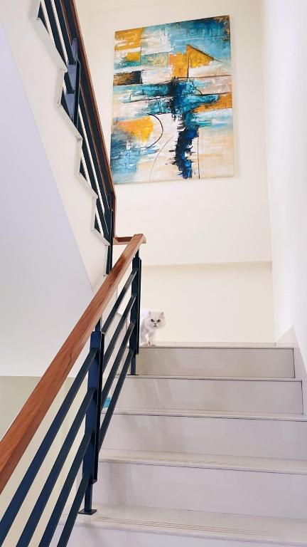 a staircase with a painting on the wall at 里舍民宿 in Jincheng