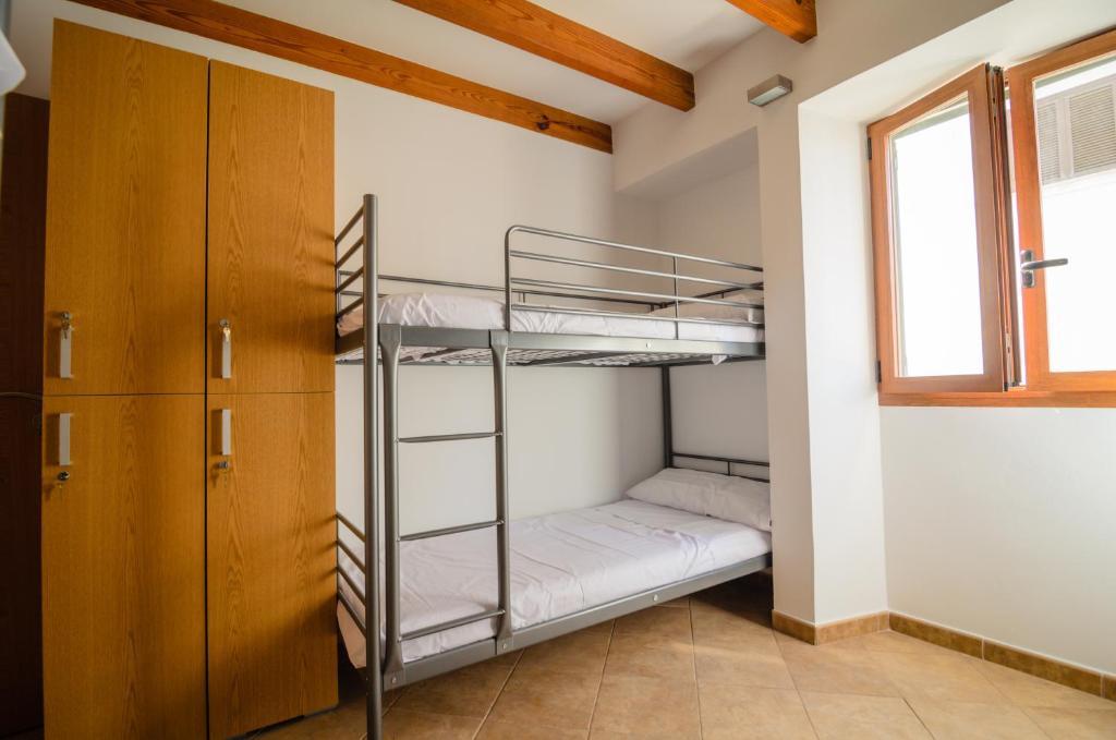 A bed or beds in a room at Embat - Hostel