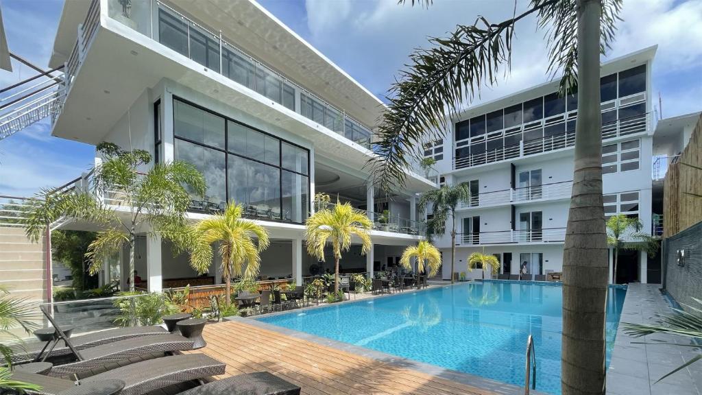 an external view of a building with a swimming pool at The XIMO Suites in Boracay