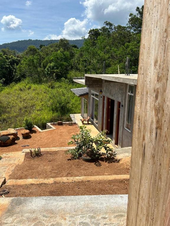 a house in the middle of a field at Hudakala Villa Hanthana in Kandy