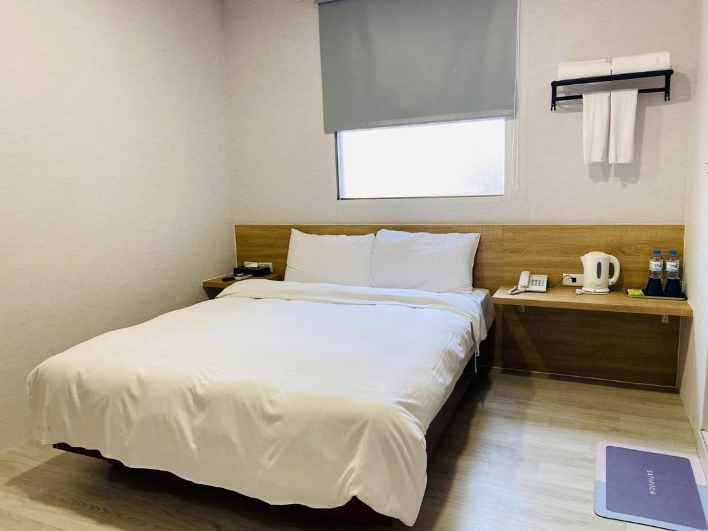 Postel nebo postele na pokoji v ubytování Beauty Garden Hotel - Jiaoxi
