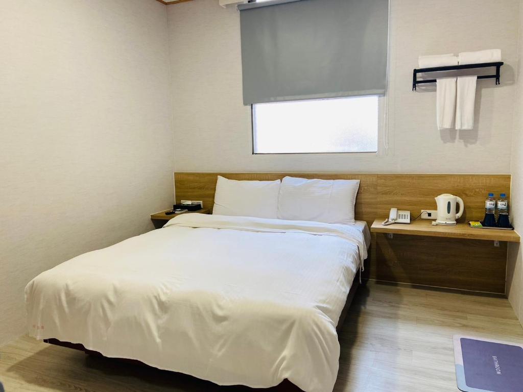 Postel nebo postele na pokoji v ubytování Beauty Garden Hotel - Jiaoxi