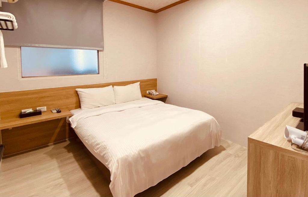 Postel nebo postele na pokoji v ubytování Beauty Garden Hotel - Jiaoxi