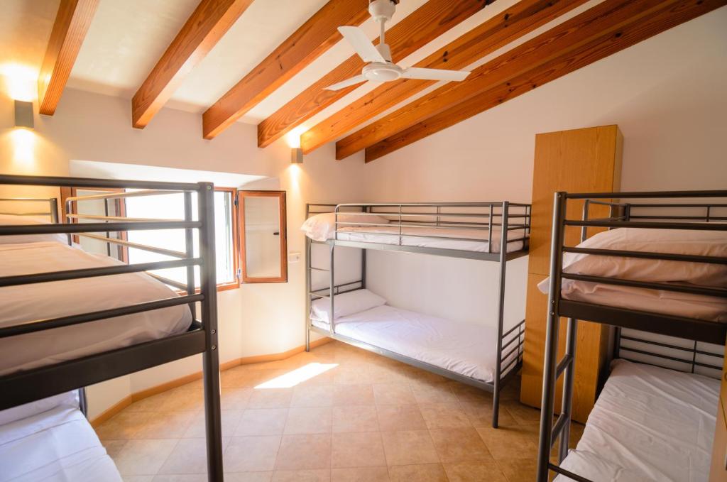 A bed or beds in a room at Embat - Hostel