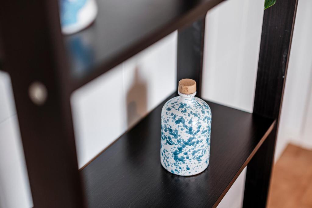 a blue and white bottle sitting on a table at Acquaterra in Polignano a Mare