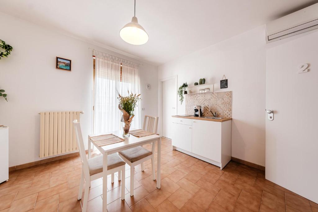 a kitchen and dining room with a table and chairs at Acquaterra in Polignano a Mare