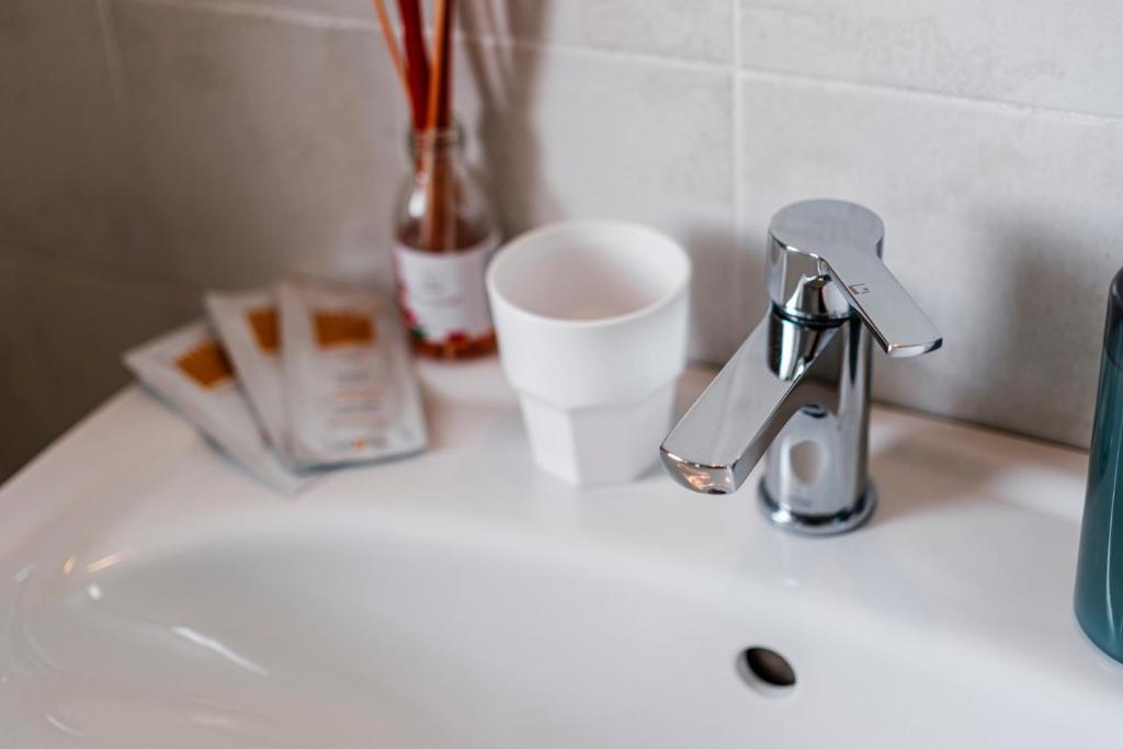 a sink with a faucet and a cup on it at Acquaterra in Polignano a Mare