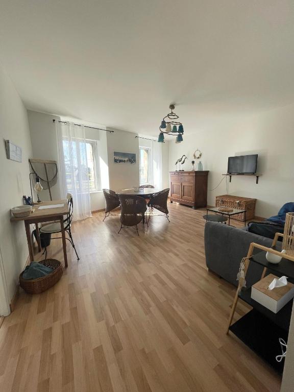 a living room with a couch and a table at Escale à Ploumanac'h in Perros-Guirec