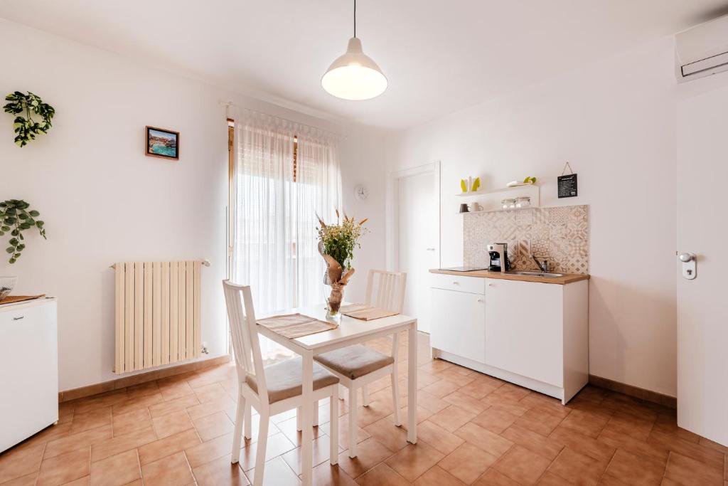 a kitchen with a table and chairs in a room at Acquaterra in Polignano a Mare