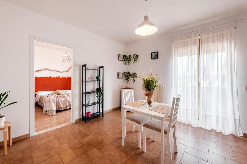 a dining room with a table and a bedroom at Acquaterra in Polignano a Mare