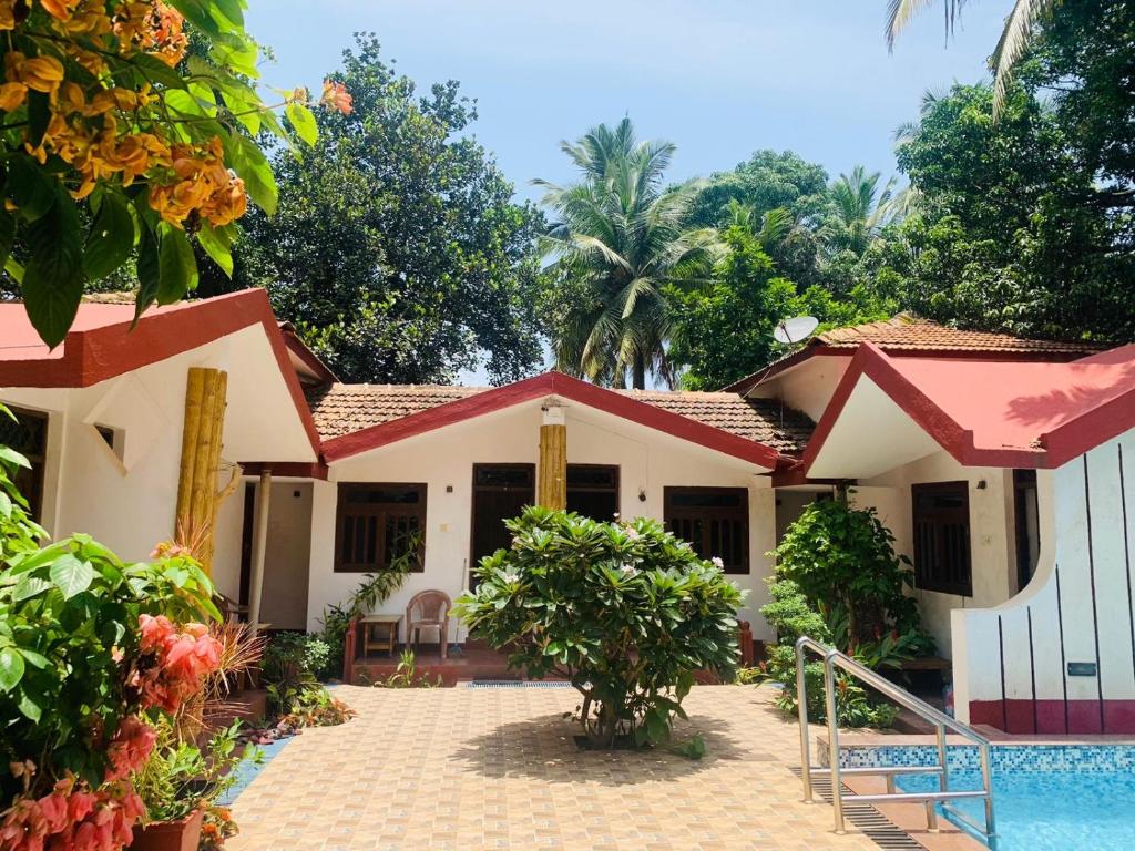 a house with a pool in front of it at Harbor Court, Vagator in Vagator