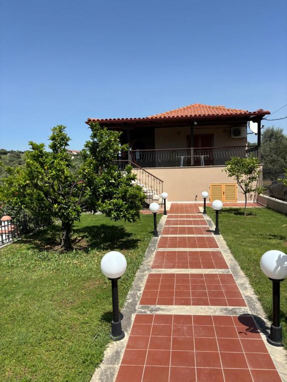 a brick walkway leading to a house at Villa Ocean in Paralia Dionysiou