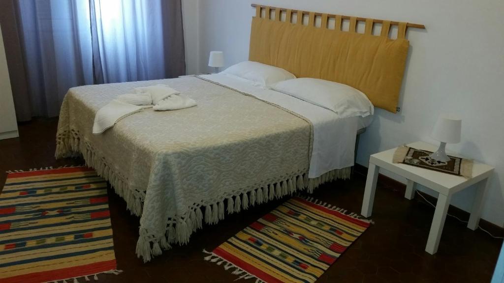 a bedroom with a bed and a table with a night stand at Il Cucù B&B in Frascati