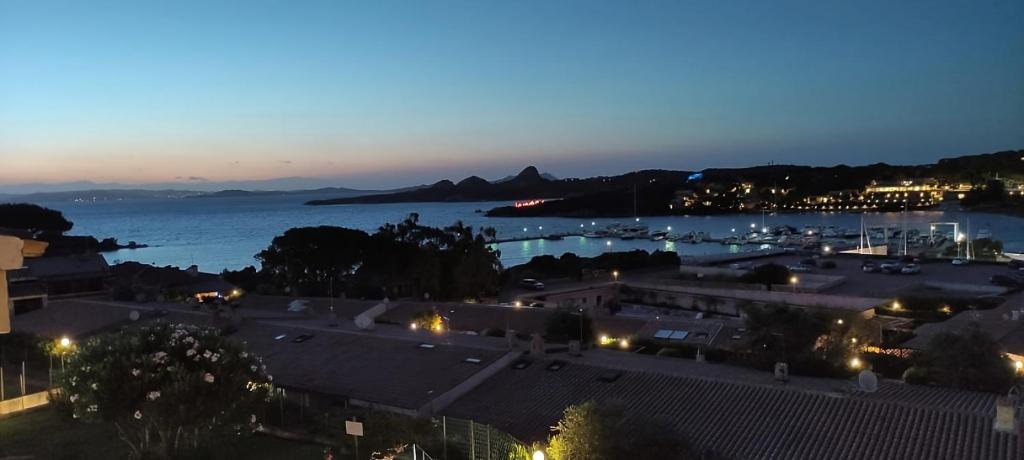 a view of a city with a harbor at night at Blue Bay Apartment in Cala Bitta