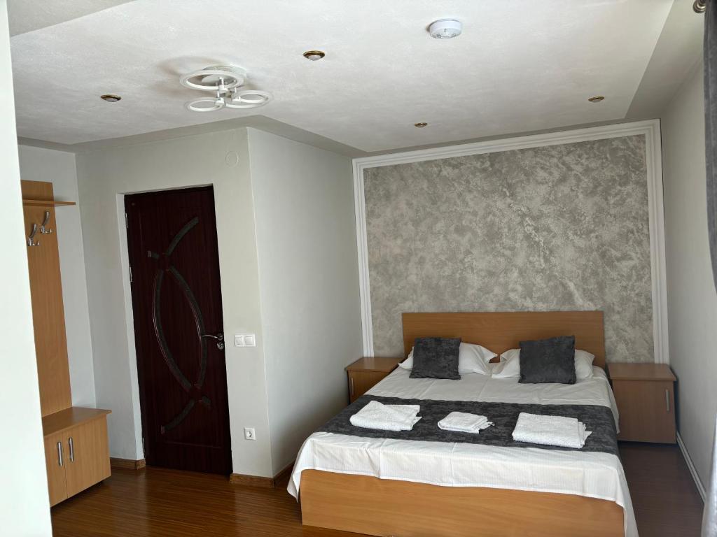 a bedroom with a bed and a ceiling fan at Casa Otilia in Chişcău