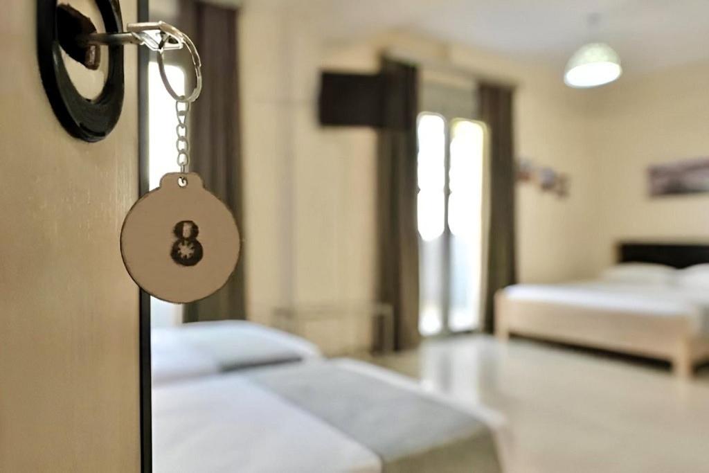 a room with a bed with a key on a door at GREEK PRIDE PANTHEA STUDIOS in Skala Fourkas