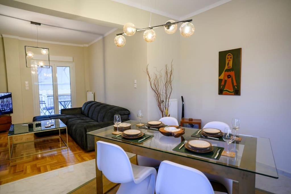 a living room with a table and white chairs at Luxury Modern 2 bed Elegance in Athens
