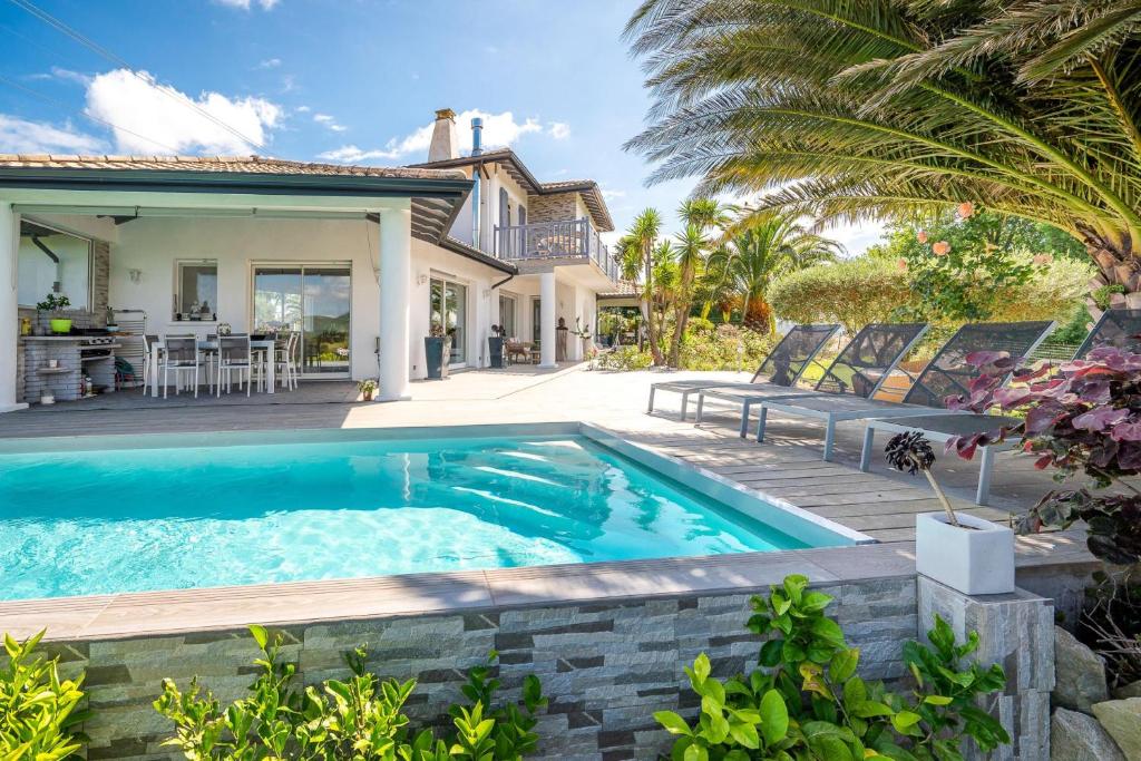 a swimming pool in the backyard of a house at Maison Madalena With Pool close to ocean 